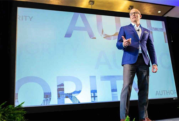 Tim Thayne speaking on stage
